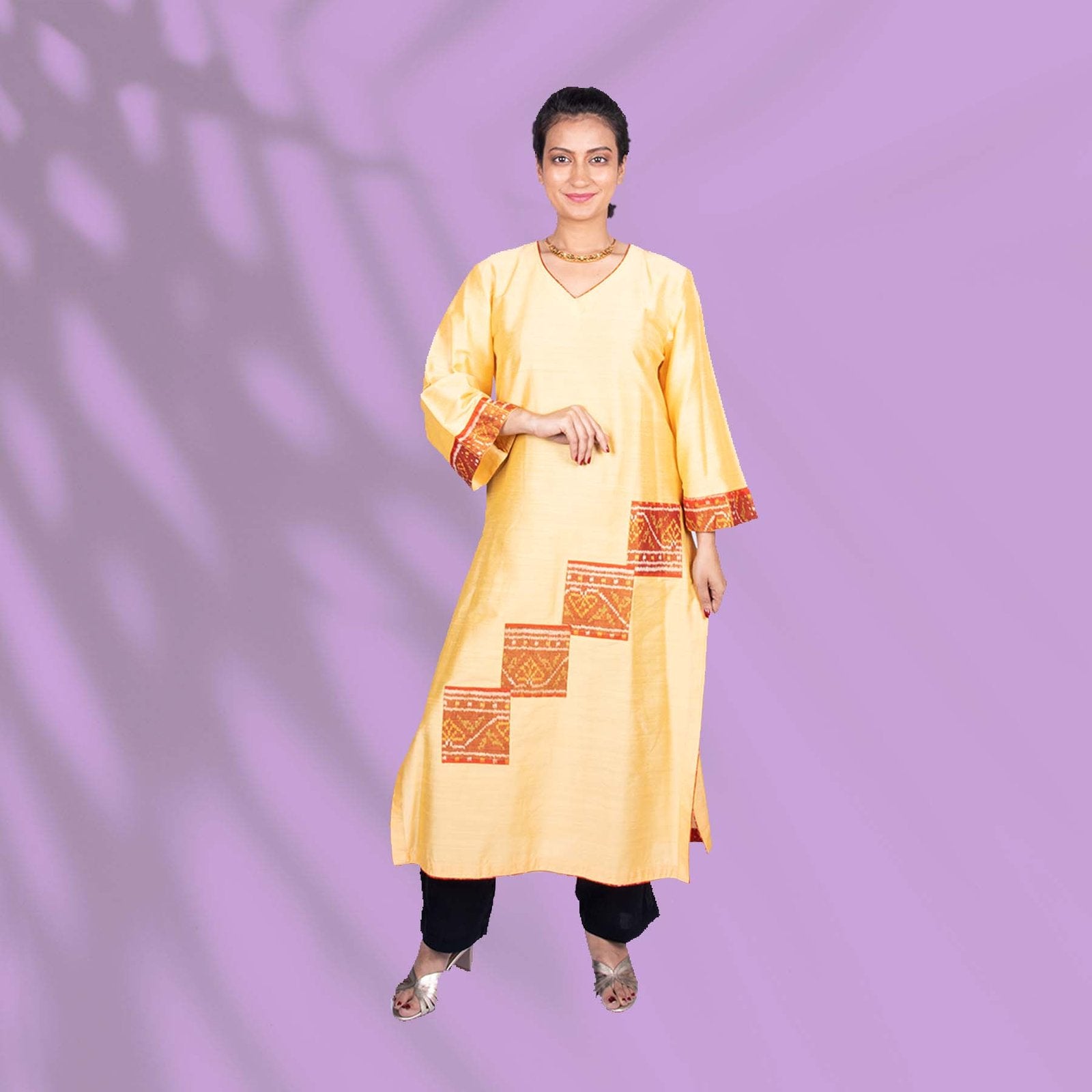 Yellow Ikkat kurta adorned with orange and red embroidery