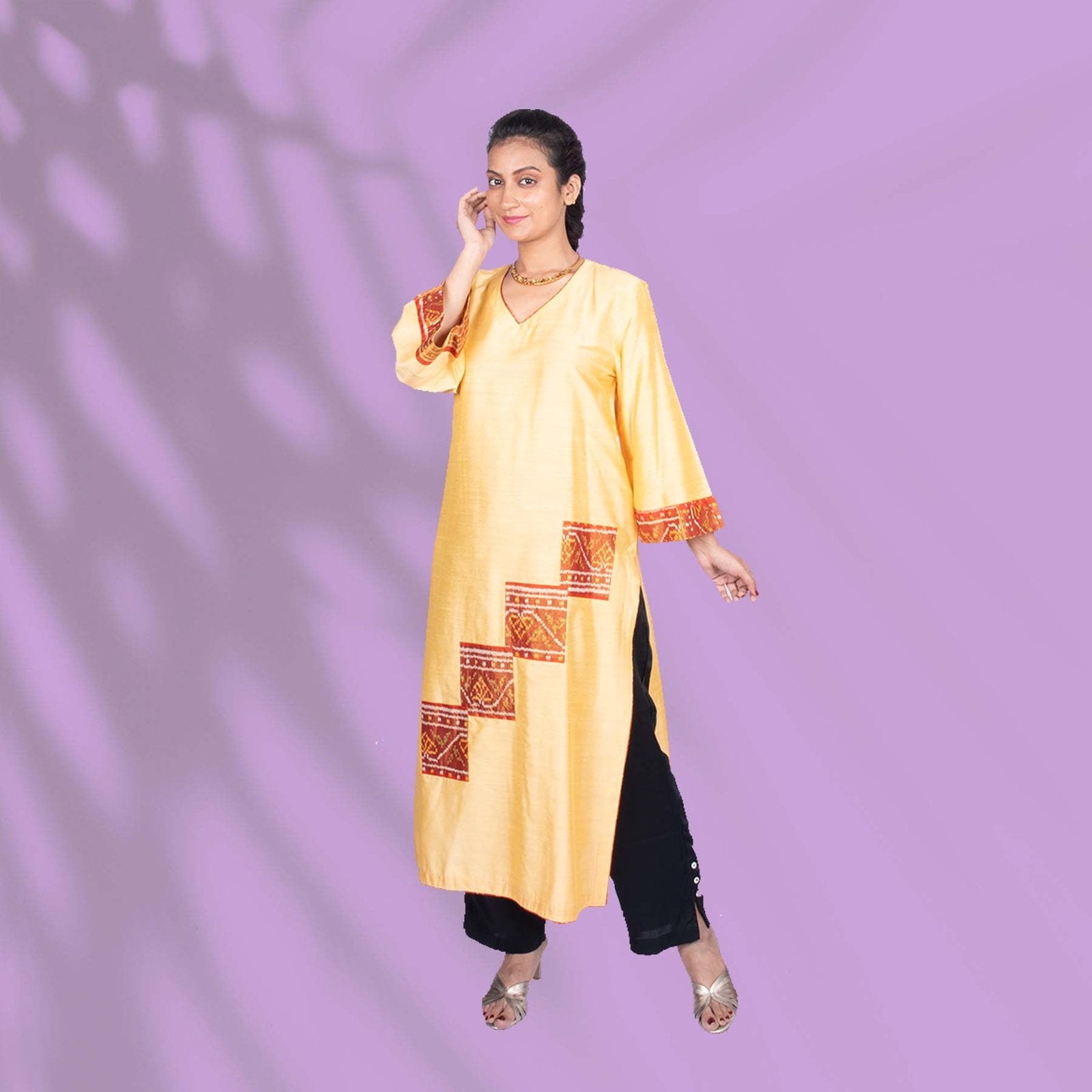 Yellow Ikkat kurta adorned with orange and red embroidery