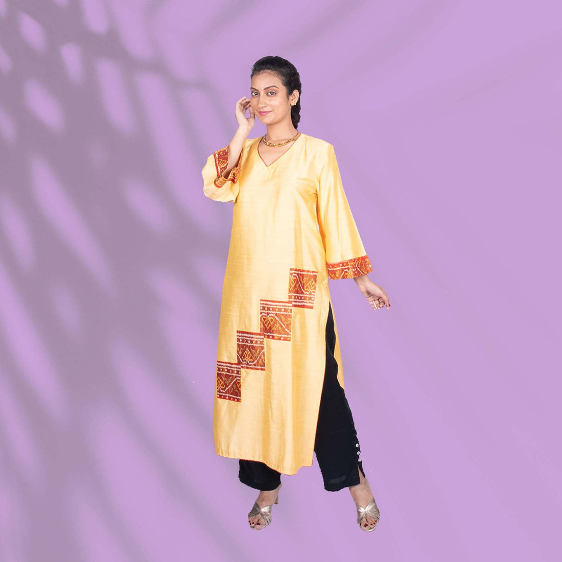 Yellow Ikkat kurta adorned with orange and red embroidery