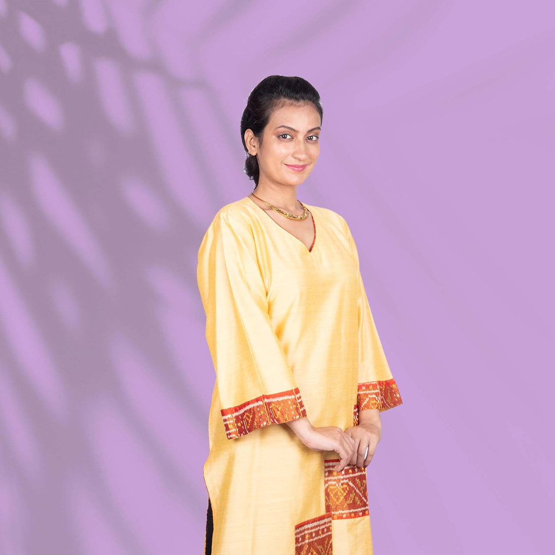 Yellow Ikkat kurta adorned with orange and red embroidery