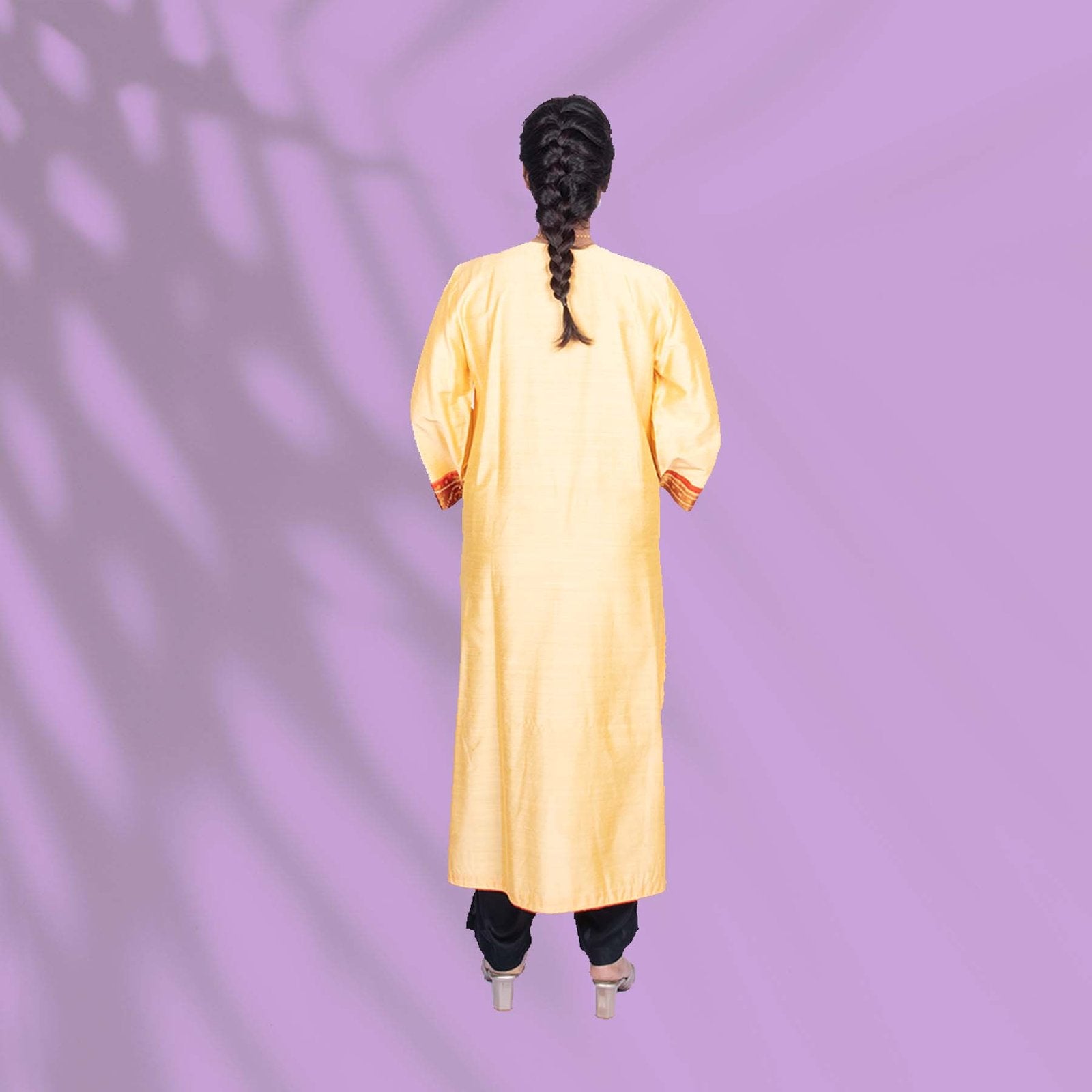 Yellow Ikkat kurta adorned with orange and red embroidery