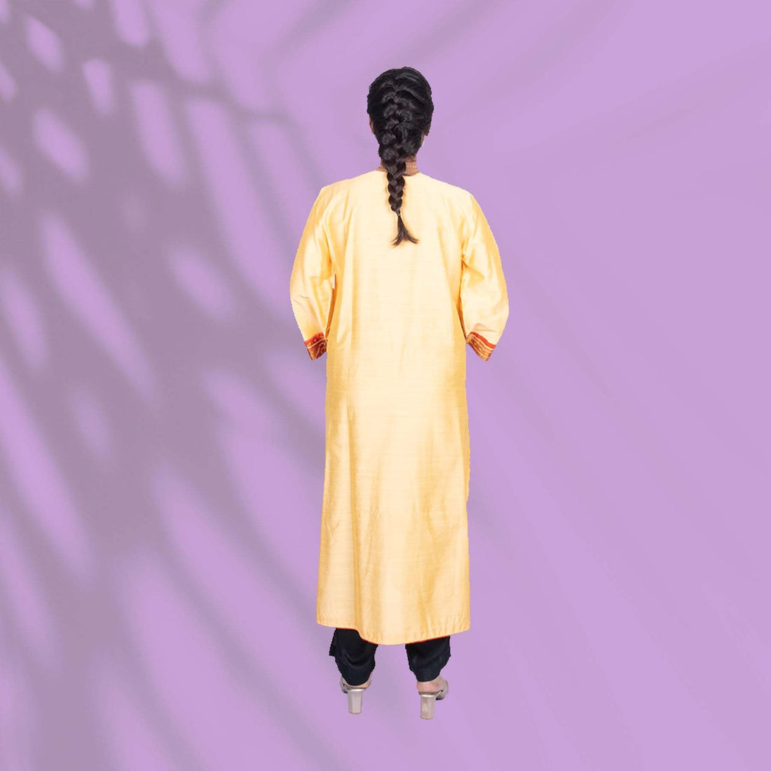Yellow Ikkat kurta adorned with orange and red embroidery